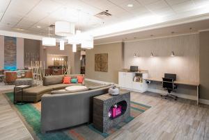 a living room with a couch and a desk at Holiday Inn Hotel & Suites Lake City by IHG in Lake City