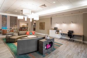 a living room with a couch and a desk at Holiday Inn Hotel & Suites Lake City, an IHG Hotel in Lake City