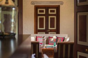 a room with a table and a door with pillows at Kumbukgaha Villa in Sigiriya