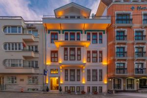 a large white building with yellow lights on it at Blue Gilroy Hotel in Istanbul