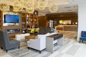 a lobby with a couch and chairs and a tv at Holiday Inn Vancouver Airport Richmond, an IHG Hotel in Richmond