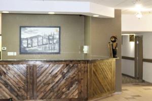 a bar in a lobby with a picture on the wall at Super 8 by Wyndham Hinton in Hinton