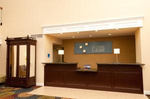 a lobby with a waiting room with a reception desk at Holiday Inn Express Hotel & Suites Bloomington-Normal University Area, an IHG Hotel in Bloomington
