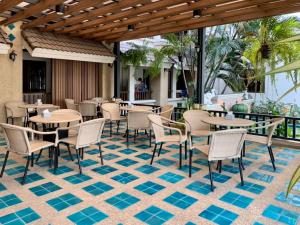a restaurant with tables and chairs on a tile floor at Suansin Lanna Hotel in Tak