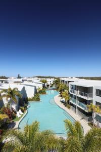 a large building with a pool of water at Sand Dunes Resort Accommodation in Marcoola