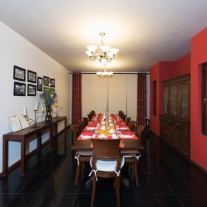 a dining room with a long table with chairs at The Walden Nuwara Eliya in Nuwara Eliya