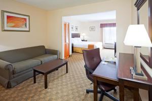 a hotel room with a couch and a bed at Holiday Inn Express Carneys Point New Jersey Turnpike Exit 1, an IHG Hotel in Carneys Point