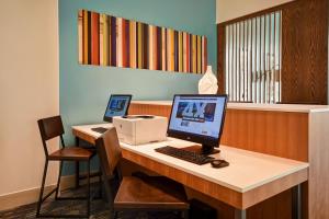 an office with a desk with a computer and a printer at Holiday Inn Express & Suites - Galveston Beach, an IHG Hotel in Galveston