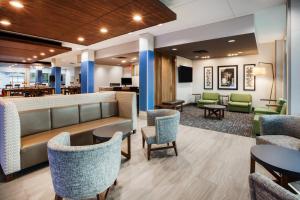 a lobby with chairs and tables and a waiting room at Holiday Inn Express Hotel & Suites Canton by IHG in Canton