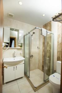 a bathroom with a shower and a sink and a toilet at The PeraPort Hotel in Istanbul