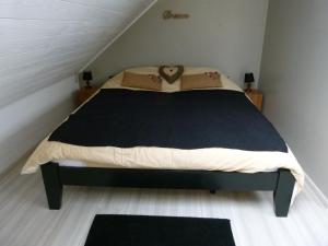 a bedroom with a large bed in a attic at Espace Bien Etre et Spa in Libin +17 photos