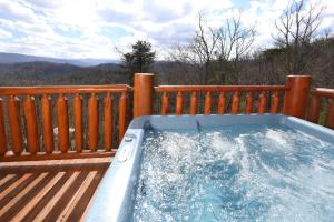 a hot tub on the deck of a house at Ridgetop Theatre Lodge Cabin in Park Settlement