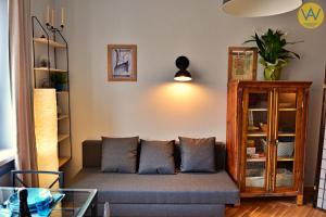 a living room with a couch and a table at Apartamenty Wójcik Loft in Gdynia