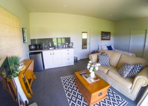 a living room with a couch and a table at Dunstan Road B&B in Alexandra