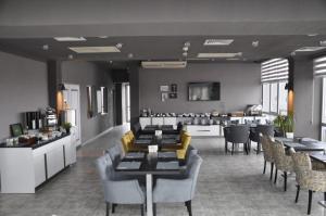 a restaurant with couches and tables and chairs at Tufad Prestige Boutique in Ankara