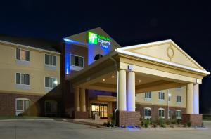 a hotel with a sign on the front of a building at Holiday Inn Express & Suites Childress by IHG in Childress