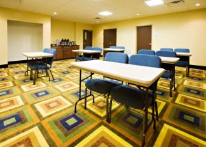 a conference room with tables and chairs on a carpet at Holiday Inn Express & Suites Childress by IHG in Childress