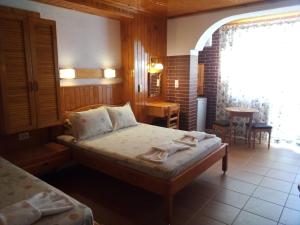 a bedroom with a bed and a table and a window at Doctor's House in Sinemorets