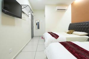 A bed or beds in a room at Mimilala Hotel @ i-City, Shah Alam
