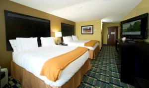 a hotel room with two beds and a flat screen tv at Holiday Inn Express & Suites Morrilton by IHG in Morrilton