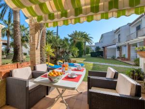 a patio with a table with a bowl of fruit on it at Holiday Home La Aldea by Interhome in Denia