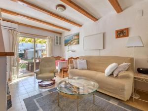 a living room with a couch and a glass table at Holiday Home La Aldea by Interhome in Denia