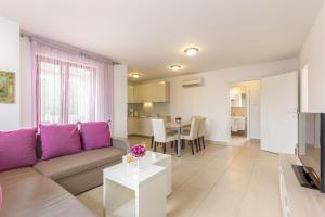 a living room with a couch and a table at Apartments Mike in Malinska