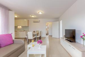 a living room with a couch and a table at Apartments Mike in Malinska