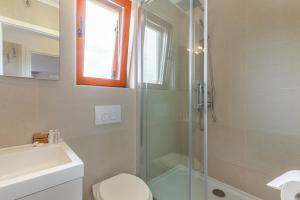 a bathroom with a shower and a toilet and a sink at Apartments Mike in Malinska +19 photos