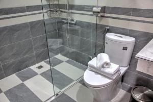 a bathroom with a toilet and a glass shower at The Flamboyant #StayWork Vinhomes Imperia in Hai Phong +23 photos
