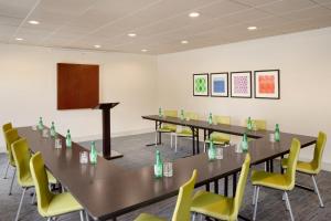 a conference room with a long table and yellow chairs at Holiday Inn Express Hotel & Suites Dallas NE - Allen, an IHG Hotel in Allen