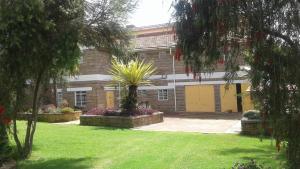 a building with a courtyard with a plant in front of it at Nyahururu Highlands Heaven -BnB in Nyahururu