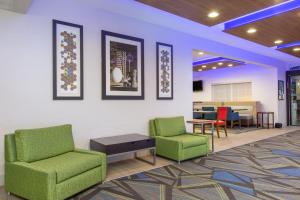 a waiting room with two chairs and a table at Holiday Inn Express Hotel & Suites Bishop, an IHG Hotel in Bishop