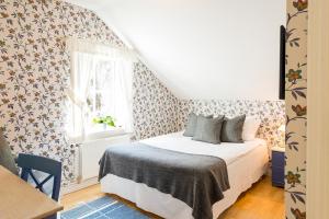 Postel nebo postele na pokoji v ubytování Krusenberg Herrgård