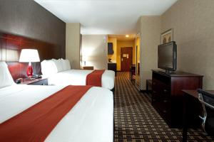 a hotel room with two beds and a flat screen tv at Holiday Inn Express Amite, an IHG Hotel in Amite