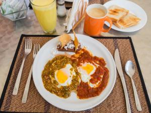 a plate with two fried eggs and toast on a table at Suites Arboleda 215 in Mexico City