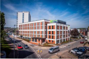 a large building on a city street with cars in traffic at Holiday Inn Express - Exeter - City Centre by IHG in Exeter