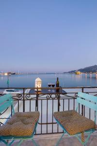 two chairs and a table with a view of the water at Andriani Apartment in Zakynthos