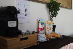 a table with a coffee maker and a drink at Little sweet escape in Caserta +16 photos