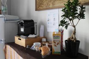 a table with a plant and a box of milk at Little sweet escape in Caserta