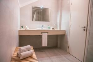 a bathroom with a sink and a mirror at Marlin House in Baleal