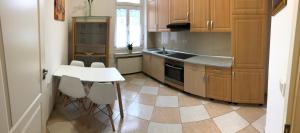 a kitchen with a table and a white table and chairs at Apartmenthaus Am Bahnhof in Detmold