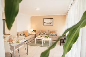 a living room with a couch and a table at Marlin House in Baleal