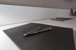 a pen sitting on top of a black keyboard at Hotel Matilde - Lifestyle Hotel in Naples