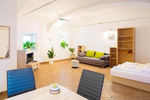 a living room with a bed and a couch at Apartment Pod velbi in Ljubljana