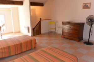 Schlafzimmer mit einem Bett, einem Schreibtisch und einem Stuhl in der Unterkunft RUMANA 1- PROCHE PLAGE ET COMMERCES - ALERIA in Aléria