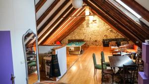an attic room with a table and a pool table at River loft in Ilirska Bistrica