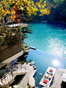 an aerial view of a lake with a dock and a boat at Volando Urai Spring Spa & Resort in Wulai
