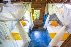 Ein Bett oder Betten in einem Zimmer der Unterkunft Swasti Eco Cottages