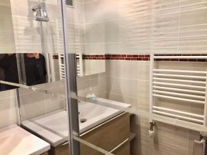 a bathroom with a glass shower and a sink at Le Gîte de Brigitte ! in Saint Die